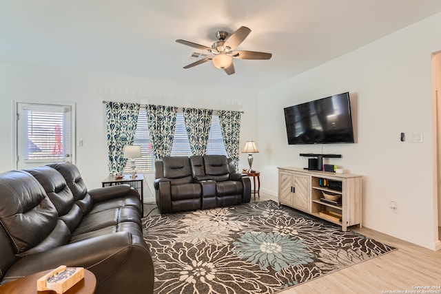 living room featuring hardwood / wood-style floors and ceiling fan