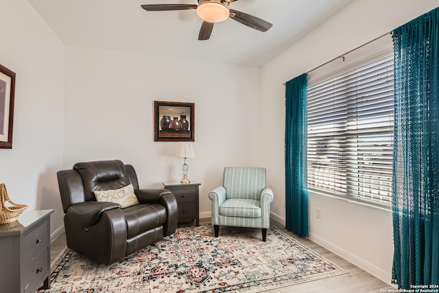 living area featuring ceiling fan and light hardwood / wood-style floors