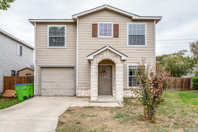 view of front of house featuring a front lawn and a garage