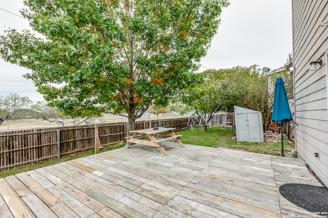 deck featuring a yard and a shed