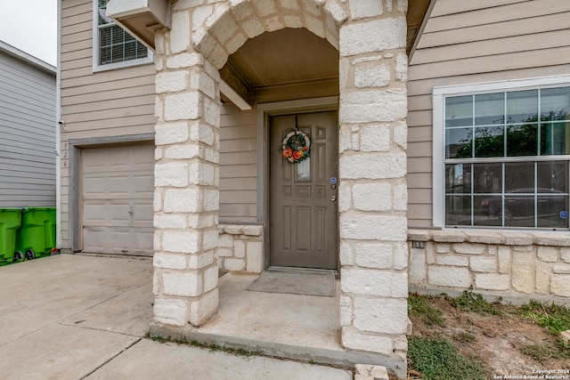 doorway to property featuring a garage