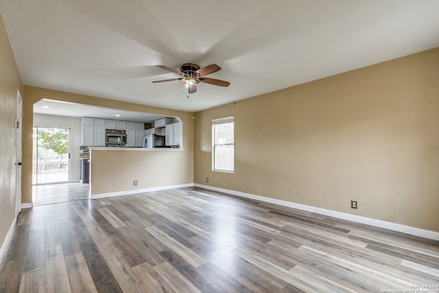 unfurnished living room featuring light hardwood / wood-style floors, ceiling fan, and a healthy amount of sunlight