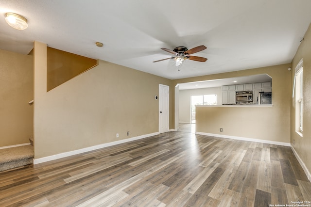 unfurnished room with hardwood / wood-style flooring and ceiling fan