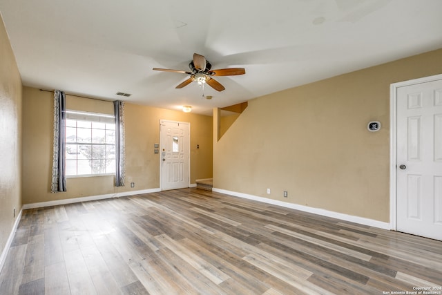 unfurnished room with ceiling fan and wood-type flooring