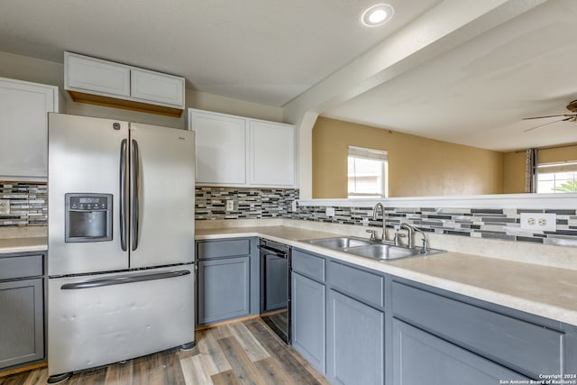 kitchen featuring decorative backsplash, sink, white cabinets, stainless steel fridge with ice dispenser, and dark hardwood / wood-style floors