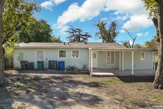 rear view of property with a patio area and cooling unit