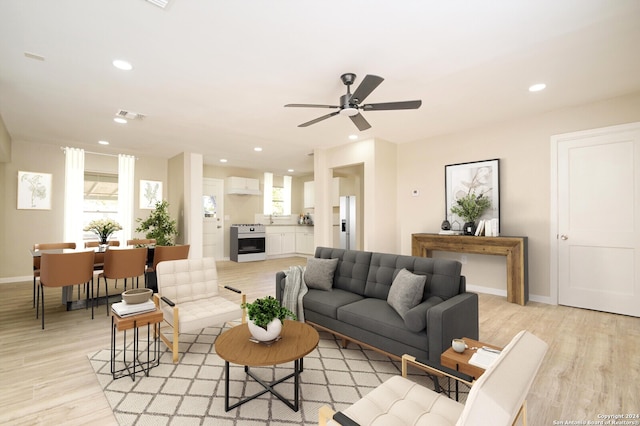 living room featuring ceiling fan and light wood-type flooring