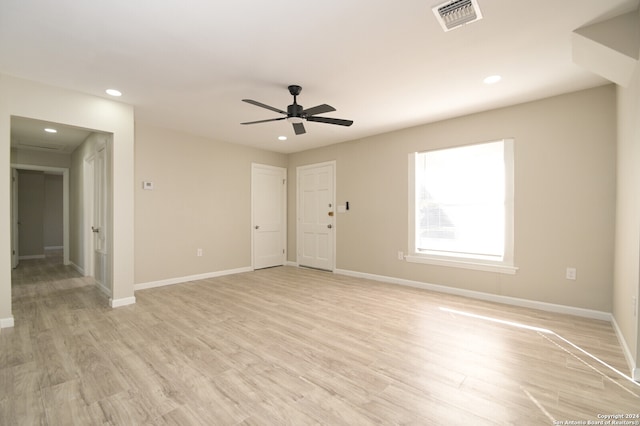 spare room featuring ceiling fan and light wood-type flooring