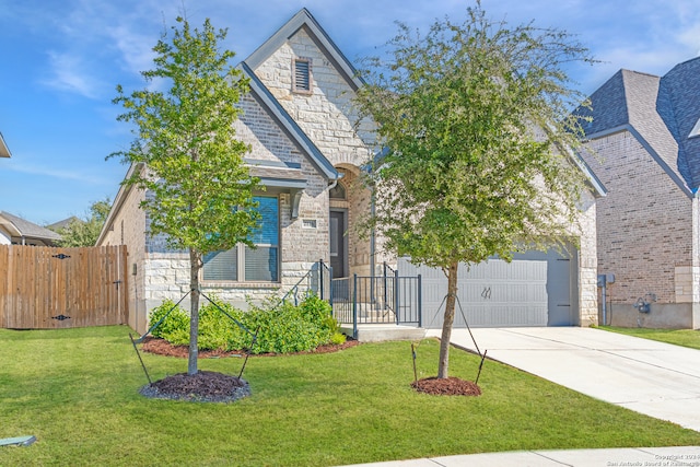 view of front facade with a front yard and a garage