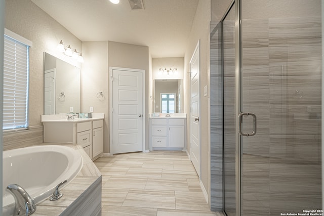 bathroom featuring plus walk in shower and vanity