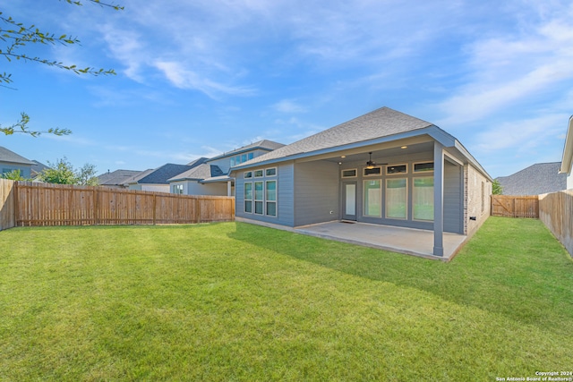 rear view of property with a patio area and a yard