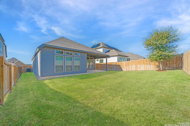 back of house featuring a yard