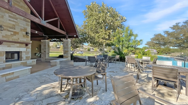 view of patio with an outdoor stone fireplace