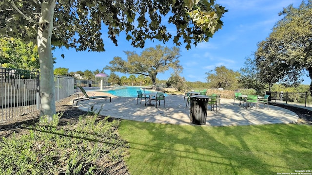 view of pool featuring a patio and a lawn