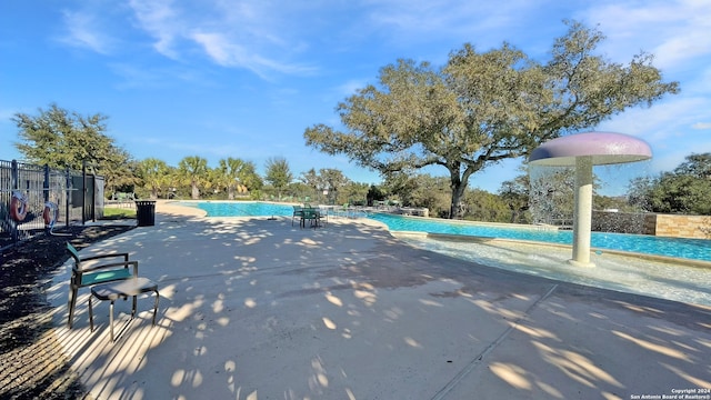 view of pool featuring pool water feature and a patio area