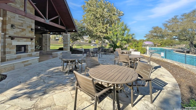 view of patio with an outdoor stone fireplace