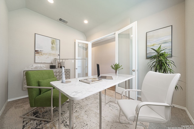 carpeted office with lofted ceiling