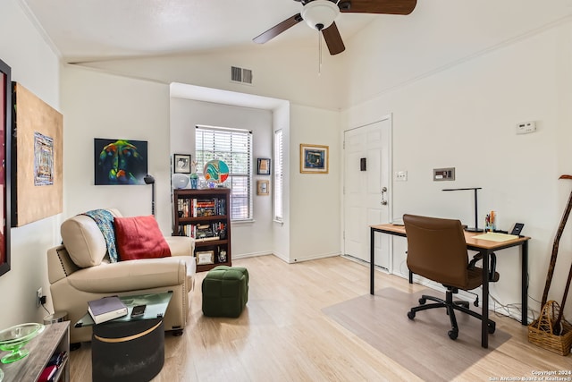 office space featuring ceiling fan, lofted ceiling, and light wood-type flooring