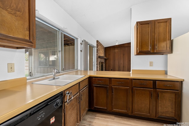 kitchen with kitchen peninsula, vaulted ceiling, sink, dishwasher, and light hardwood / wood-style floors