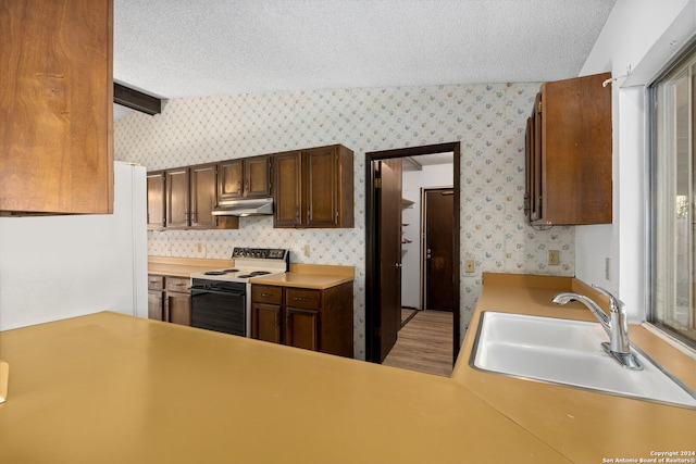 kitchen featuring vaulted ceiling with beams, sink, white electric range oven, and a textured ceiling