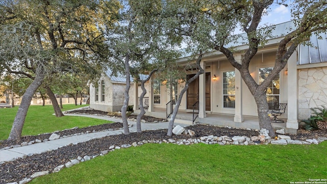306 Hornpipe Hls, San Antonio, TX 78260 - view of front facade featuring a front yard, stone siding, and stucco siding