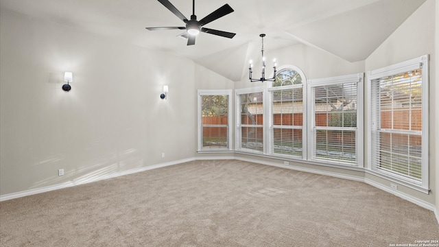 interior space featuring ceiling fan with notable chandelier and lofted ceiling