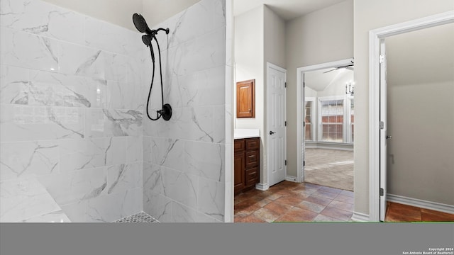 bathroom with vanity, ceiling fan, and tiled shower