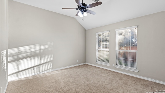 unfurnished room featuring ceiling fan, light colored carpet, and lofted ceiling