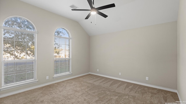 carpeted empty room with vaulted ceiling and ceiling fan