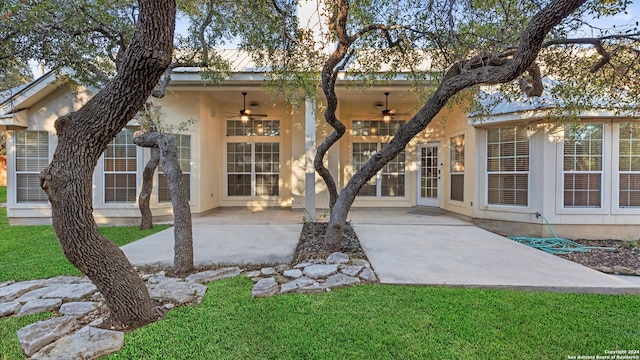 rear view of house with a lawn, a patio area, and ceiling fan