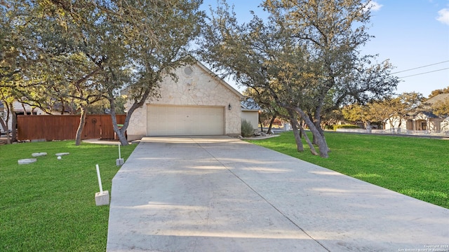 view of front of home with a front yard and a garage