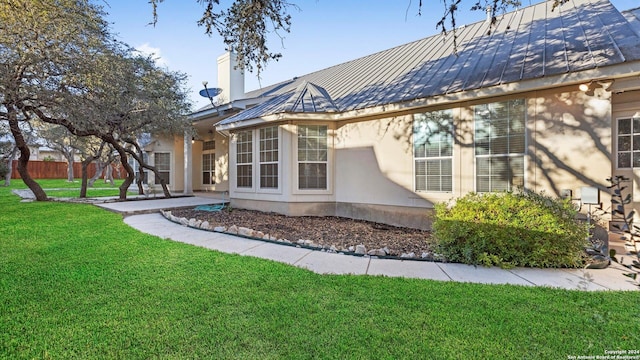 306 Hornpipe Hls, San Antonio, TX 78260 - rear view of property with stucco siding, metal roof, a standing seam roof, a chimney, and a patio