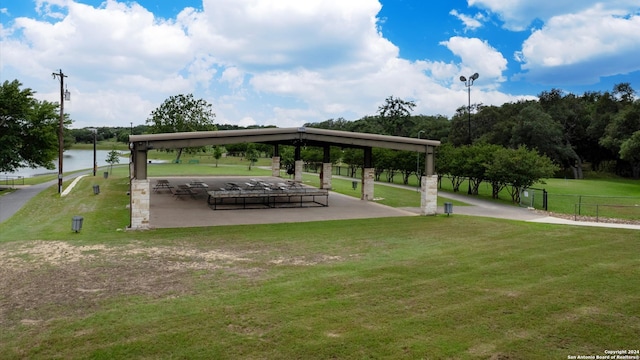 view of home's community with a lawn and a water view