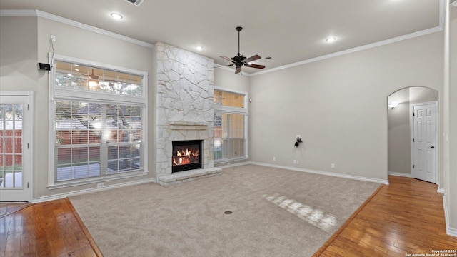 306 Hornpipe Hls, San Antonio, TX 78260 - unfurnished living room with ceiling fan, arched walkways, wood finished floors, crown molding, and baseboards