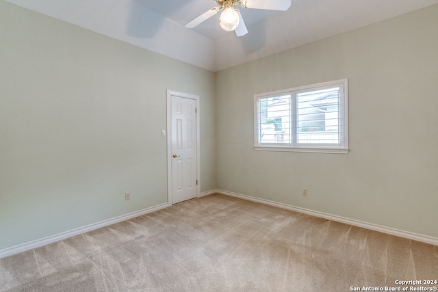 carpeted spare room with ceiling fan