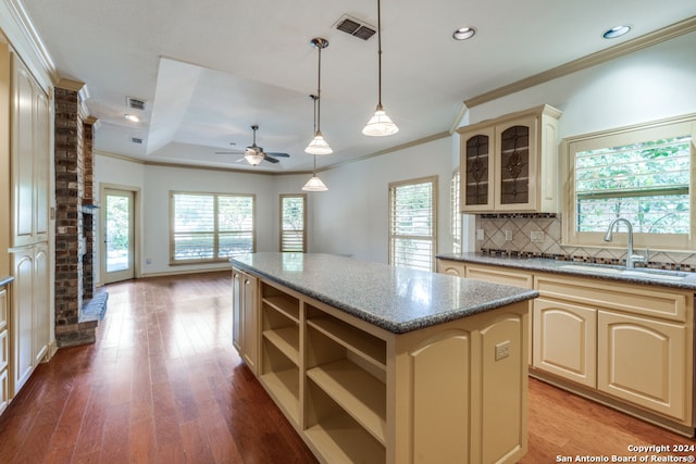 kitchen featuring ceiling fan, sink, hardwood / wood-style flooring, a center island, and hanging light fixtures