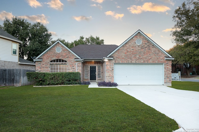 view of front of property featuring a garage and a yard