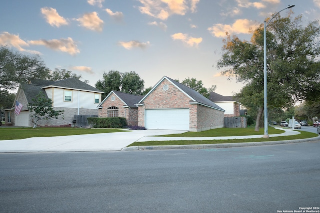 front facade featuring a yard and a garage