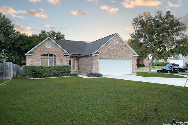 view of front of house featuring a lawn and a garage