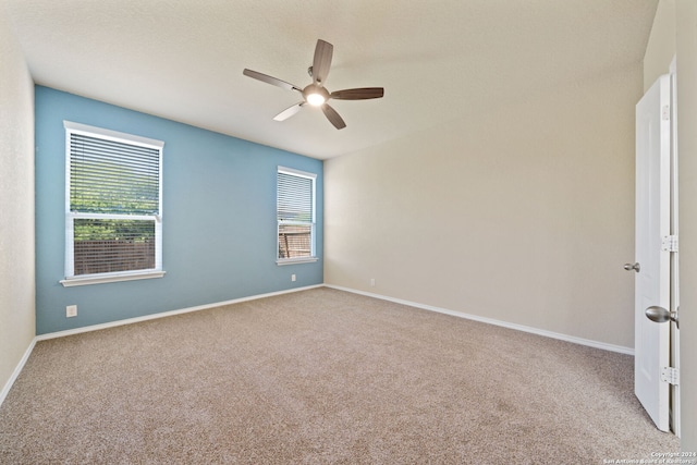 carpeted spare room with ceiling fan