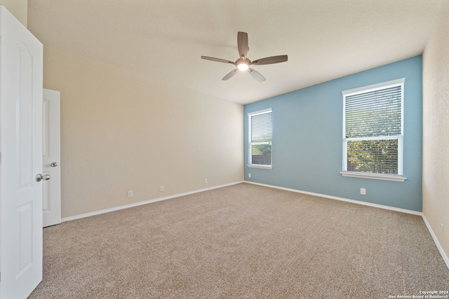 carpeted empty room featuring ceiling fan