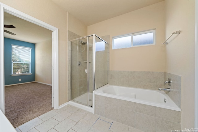 bathroom with tile patterned floors, ceiling fan, and plus walk in shower