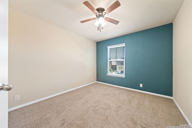 spare room with carpet and ceiling fan