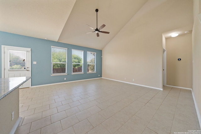 unfurnished living room with ceiling fan, light tile patterned floors, and high vaulted ceiling