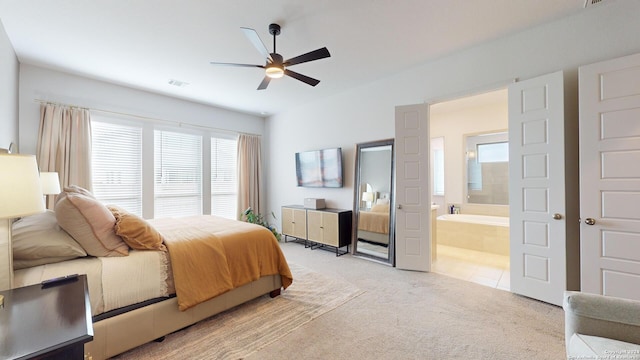 carpeted bedroom with connected bathroom and ceiling fan