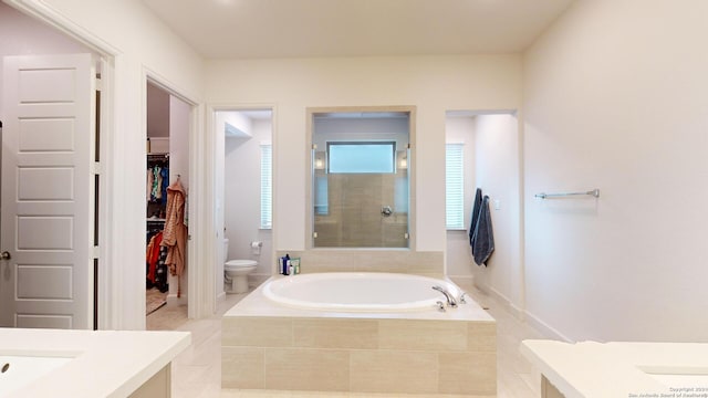 full bathroom featuring tile patterned floors, toilet, vanity, and shower with separate bathtub