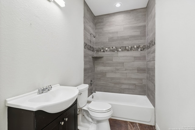 full bathroom featuring vanity, toilet, and tiled shower / bath