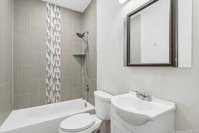 full bathroom with vanity, tiled shower / bath combo, and toilet