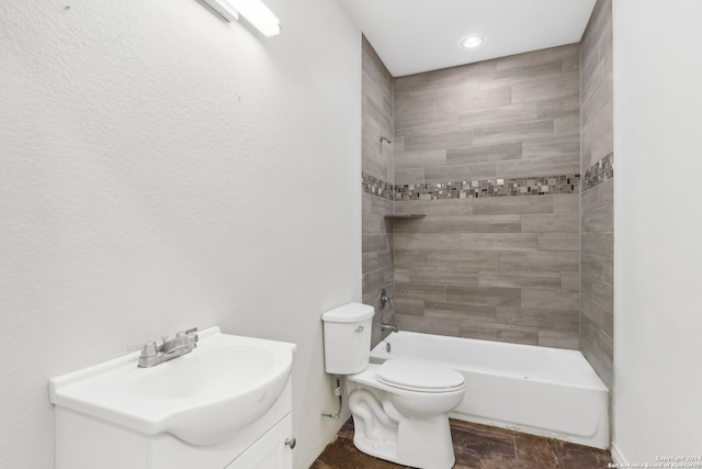 full bathroom with tiled shower / bath combo, toilet, and vanity