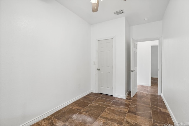 interior space with ceiling fan